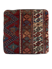 Caucasian vintage rug pillow in ruby red with blue, teal and cream accents in a geometric pattern.
