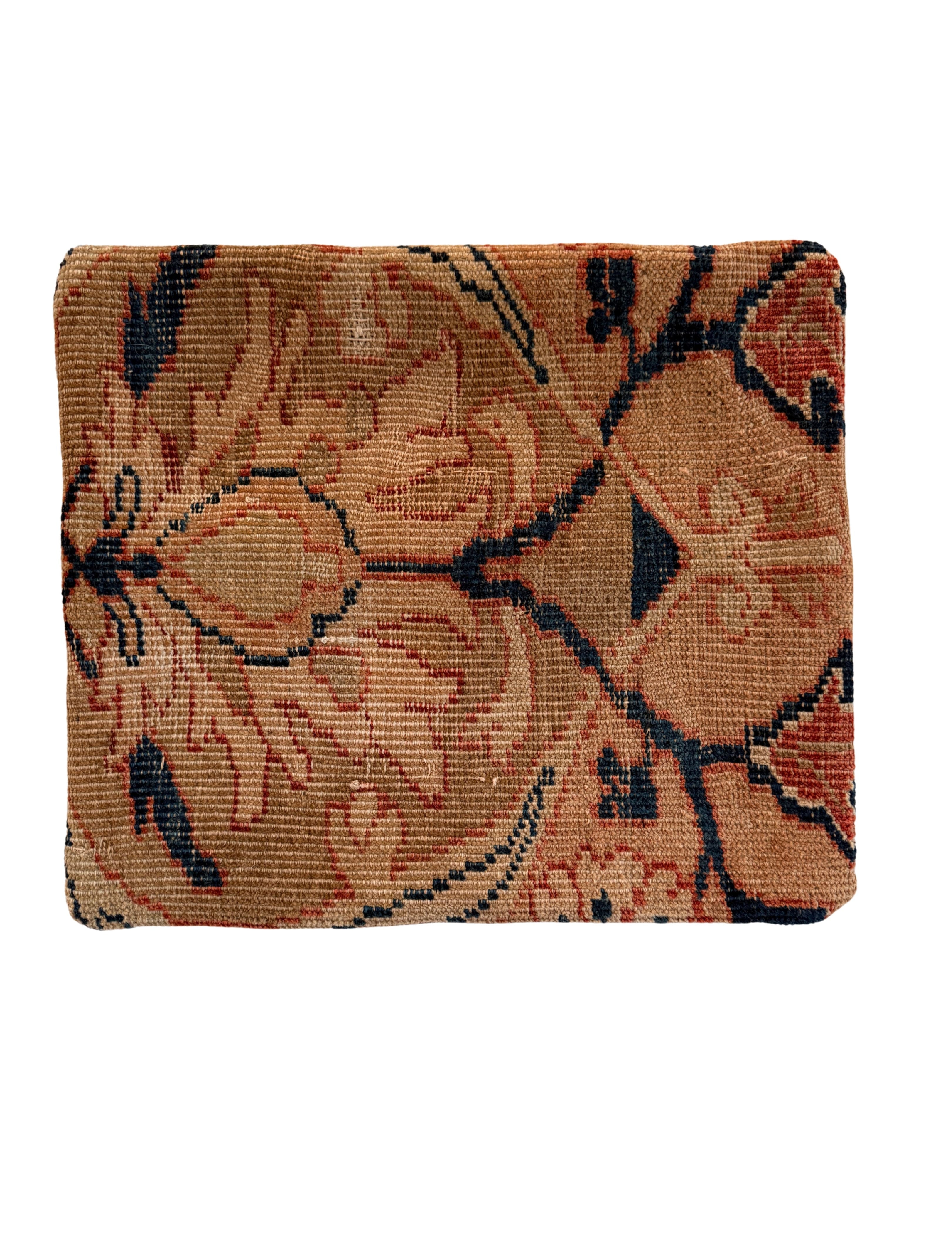 Vintage handwoven wool rug pillow with  softened shades of persimmon, tan and navy accents.