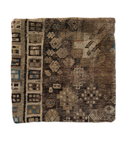 vintage rug pillow made from handwoven wool with muted brown and teal geometric pattern.