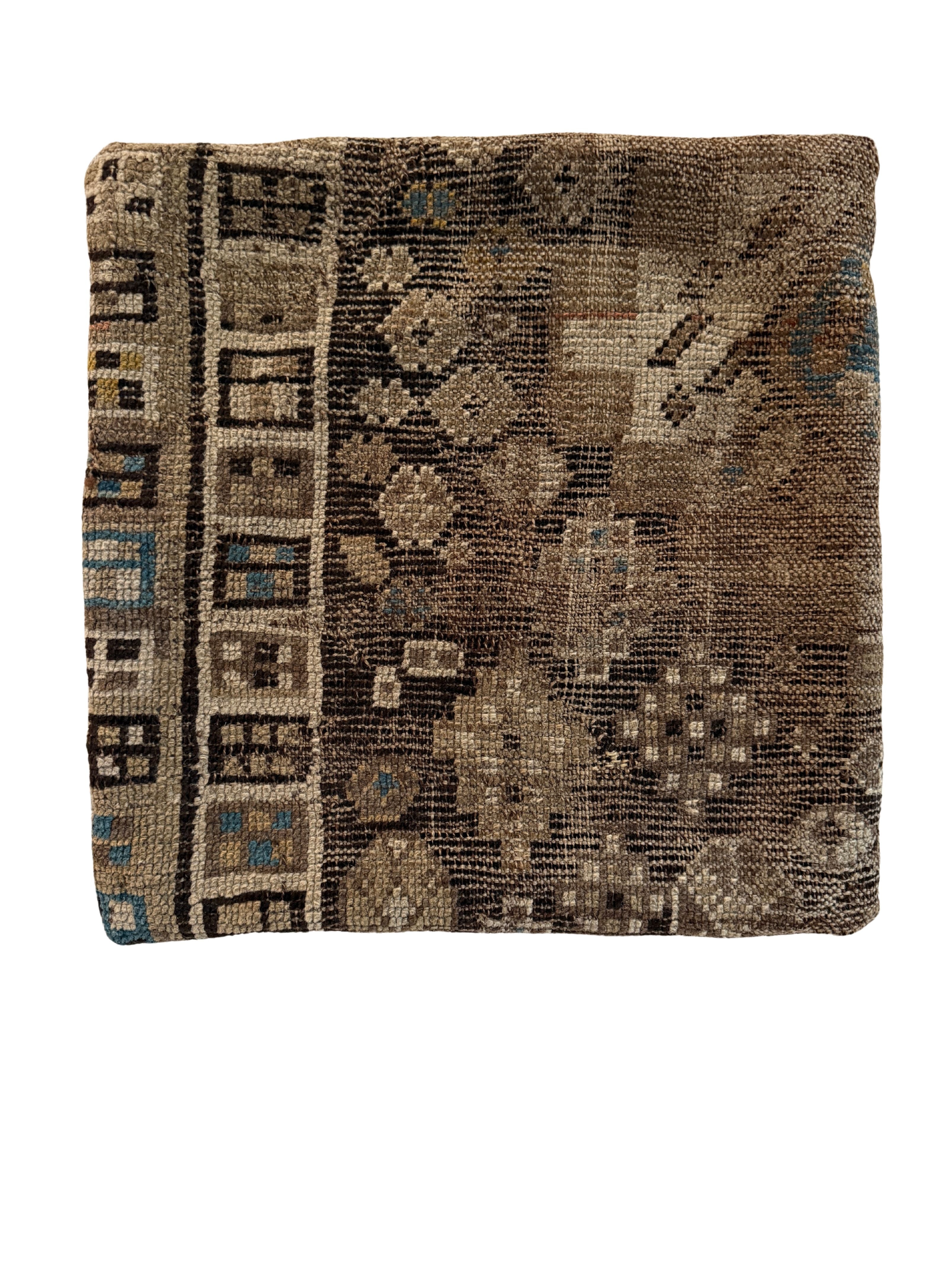 vintage rug pillow made from handwoven wool with muted brown and teal geometric pattern.