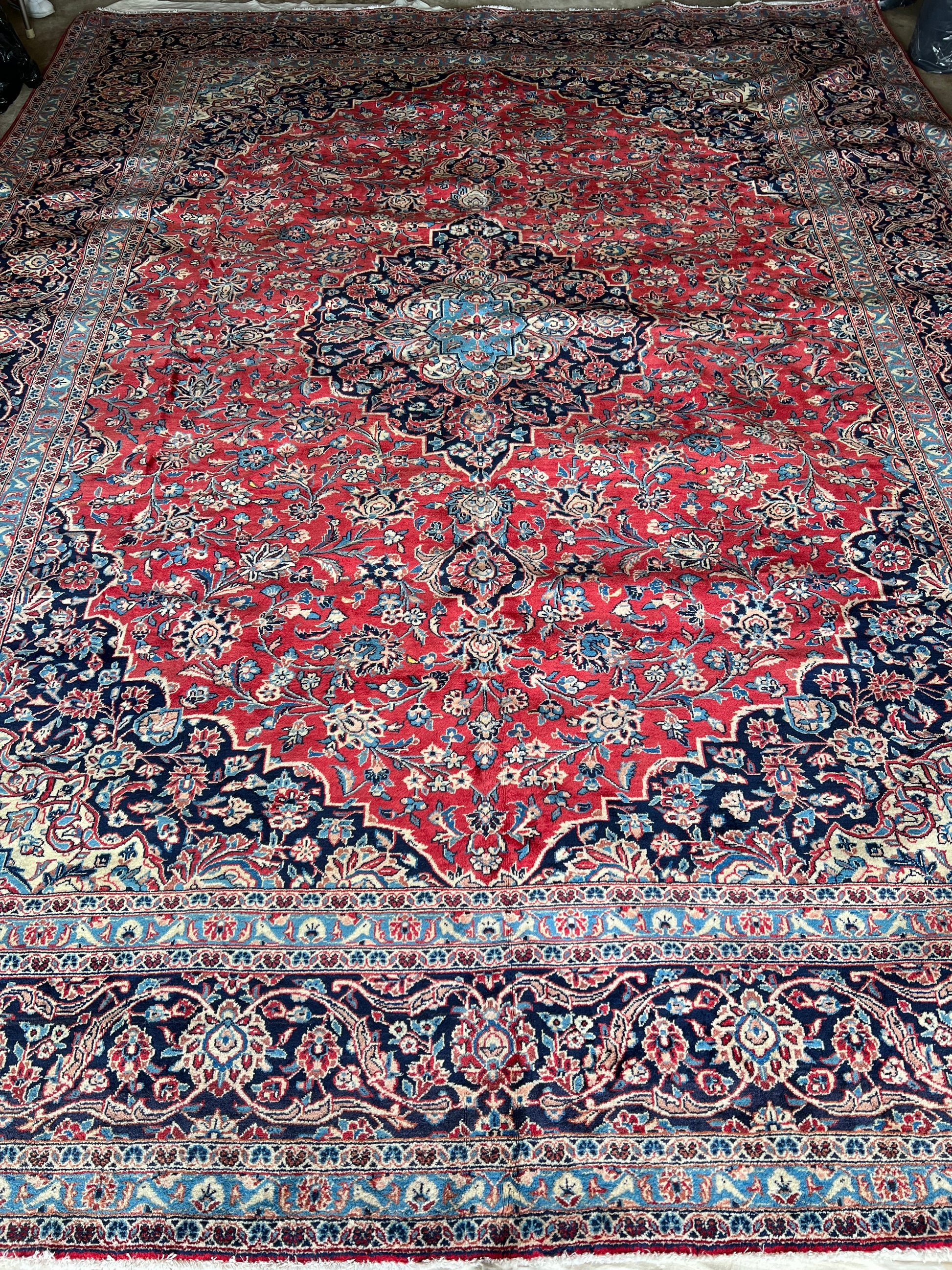 13′8″ × 10′2″ hand-knotted Persian Kashan wool rug, deep navy medallion with red floral motifs