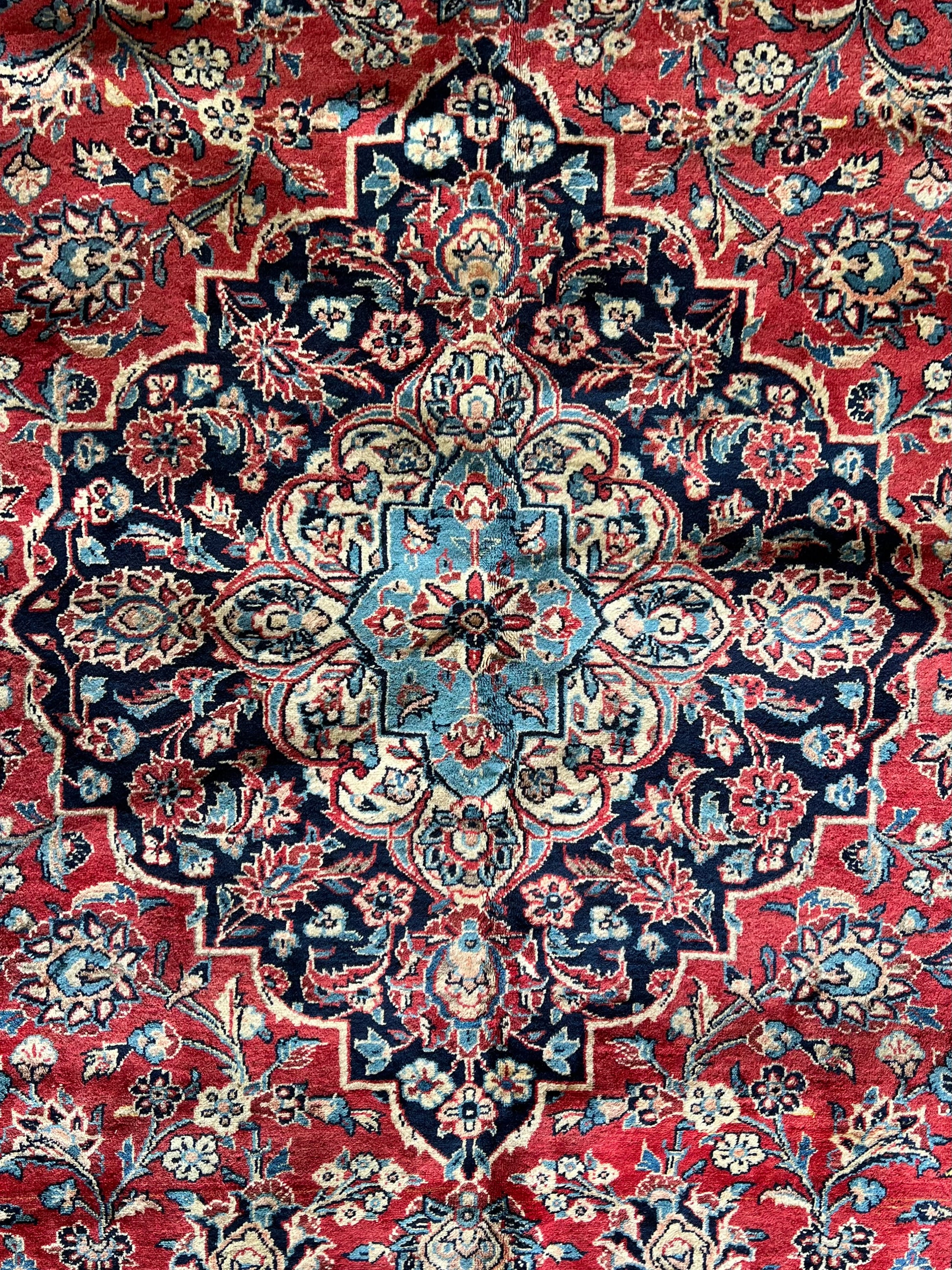 Close-up of Lachlan Persian Kashan rug central medallion, showing intricate floral motifs and knot detail