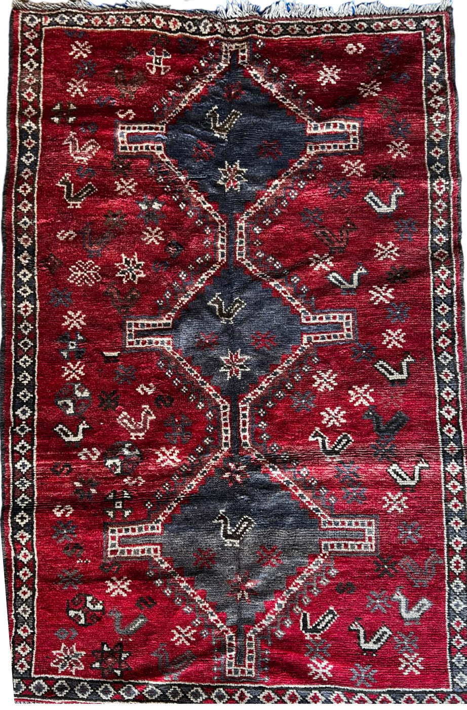Vintage Persian Qashqai tribal wool rug, 5x8, with geometric, bird and snowflakes motifs.