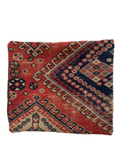 turkish vintage hand-knotted rug pillow with a red ground and navy, tan and teal accents.